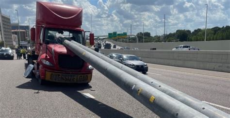 Truck driver uninjured after utility poles crash through windshield on Florida interstate